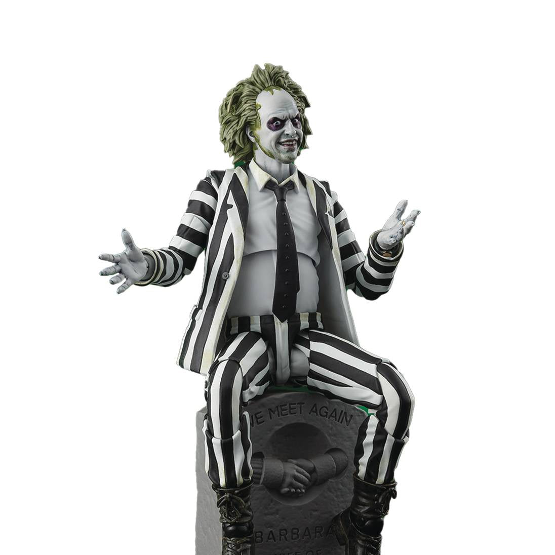 Statue of a character in a striped suit sitting on a gravestone with a white background