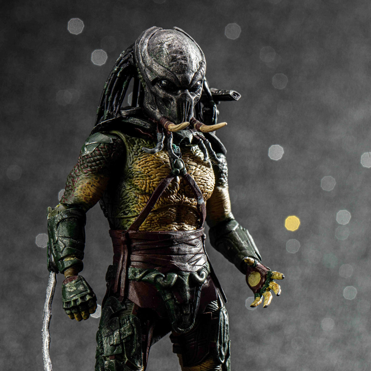 Predator action figure on a dark background