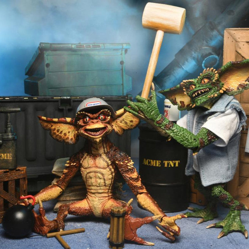 Two Gremlins action figures in a scene with a blue background
