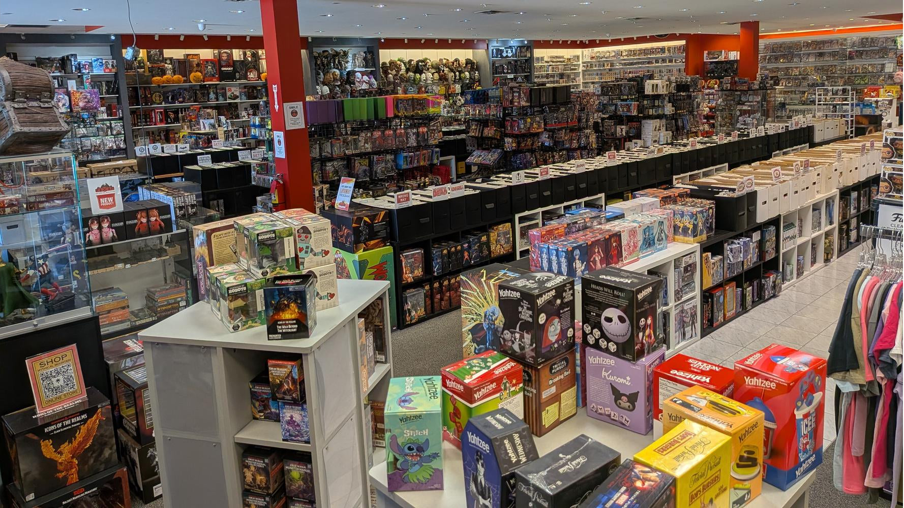 Comic book store with shelves and tables filled with various comic books and collectibles.