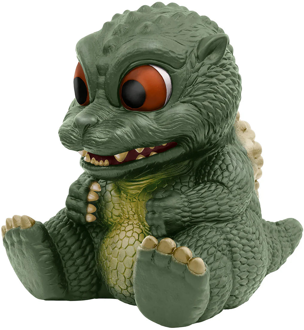 Green dinosaur-like figurine with large eyes on a white background
