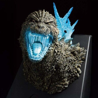 Monster-like creature head with glowing blue mouth on a black background