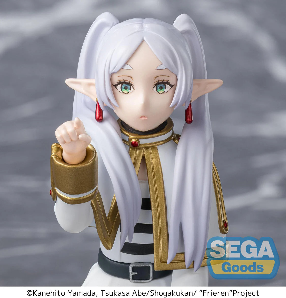 Frieren Figurine with white hair and pointed ears, wearing a white and gold outfit, with 'SEGA Goods' logo.