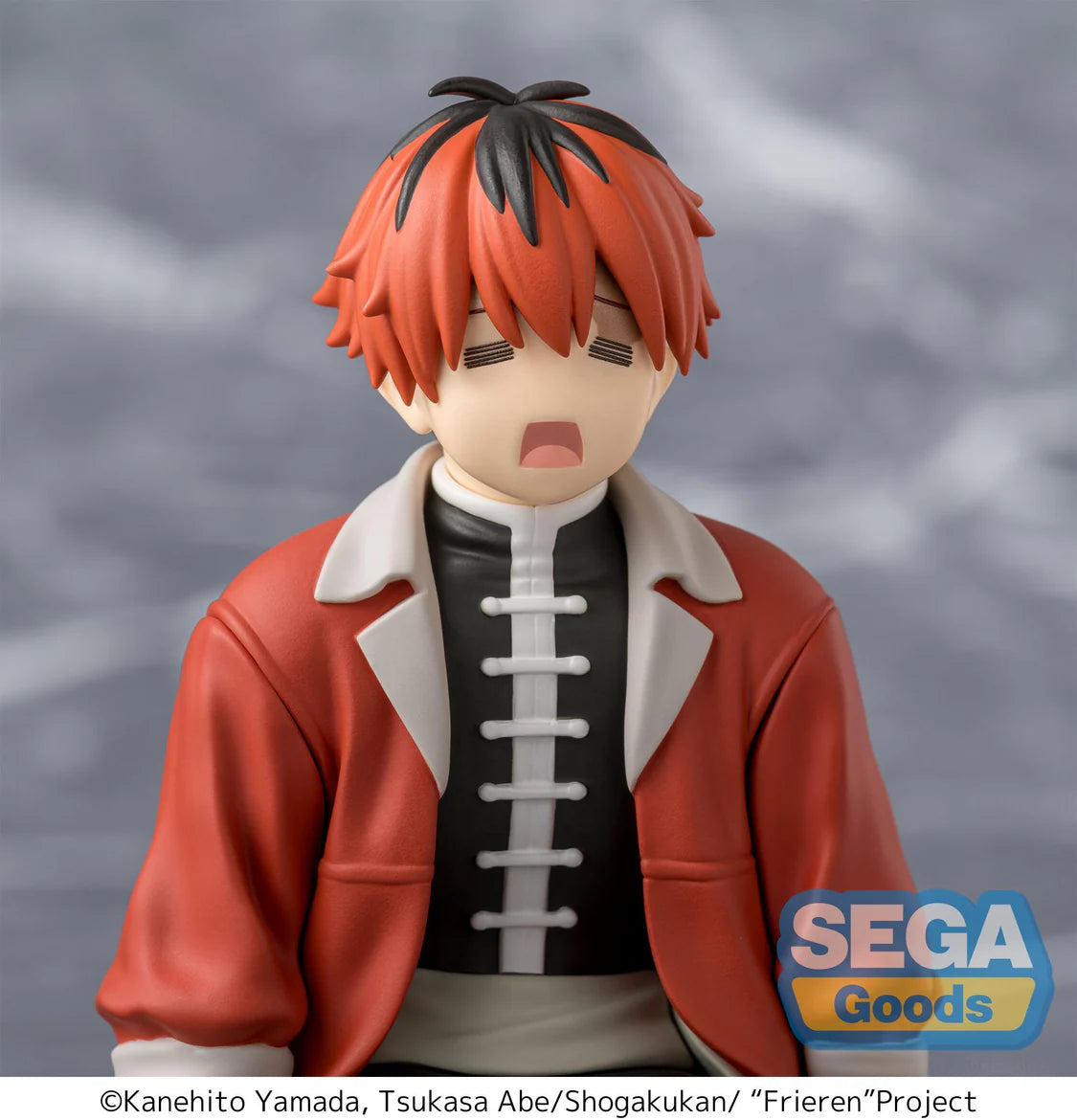 A collectible action figure of the character Renji Sakuma from Frieren, wearing a red jacket over a black and white top, with orange and black hair. The SEGA Goods logo is visible in the bottom right corner. - Action Figures - Anime