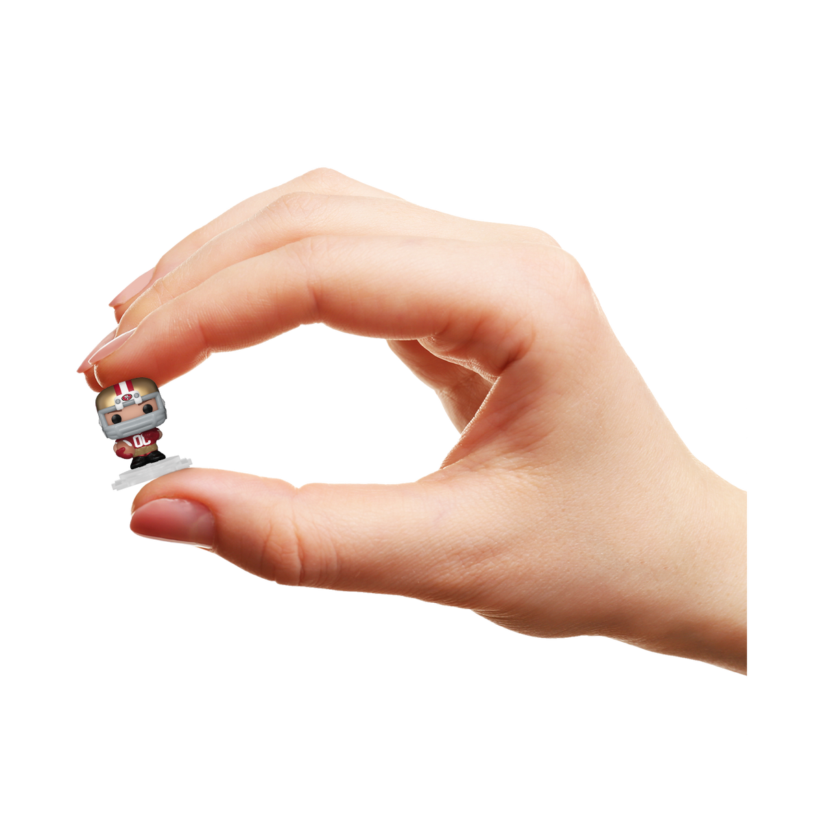 Hand holding a miniature San Francisco 49ers Bitty Pop! player in a gold helmet and red football uniform.