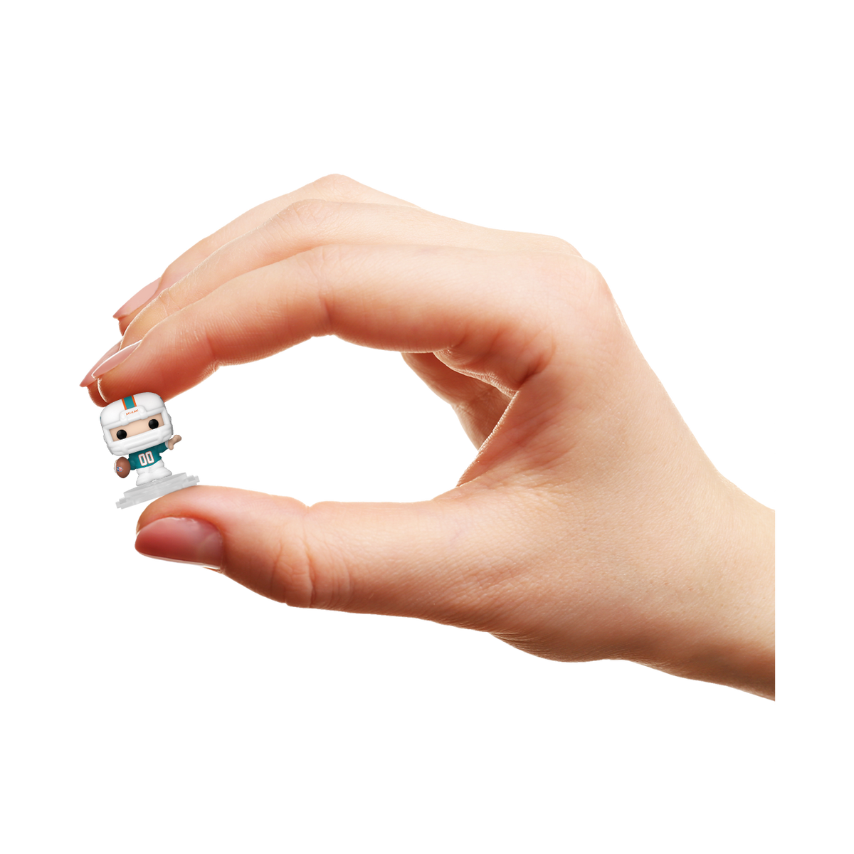 Hand holding a miniature Miami Dolphins Bitty Pop! player in an aqua helmet and white football uniform.