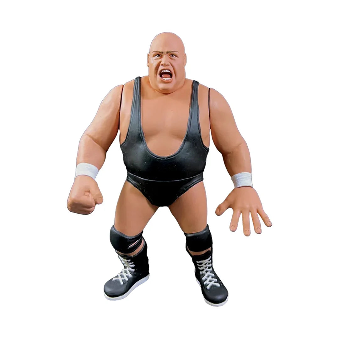 A plastic action figure of a bald wrestler with a muscular build, wearing a black singlet, black knee pads, and black wrestling boots with white laces