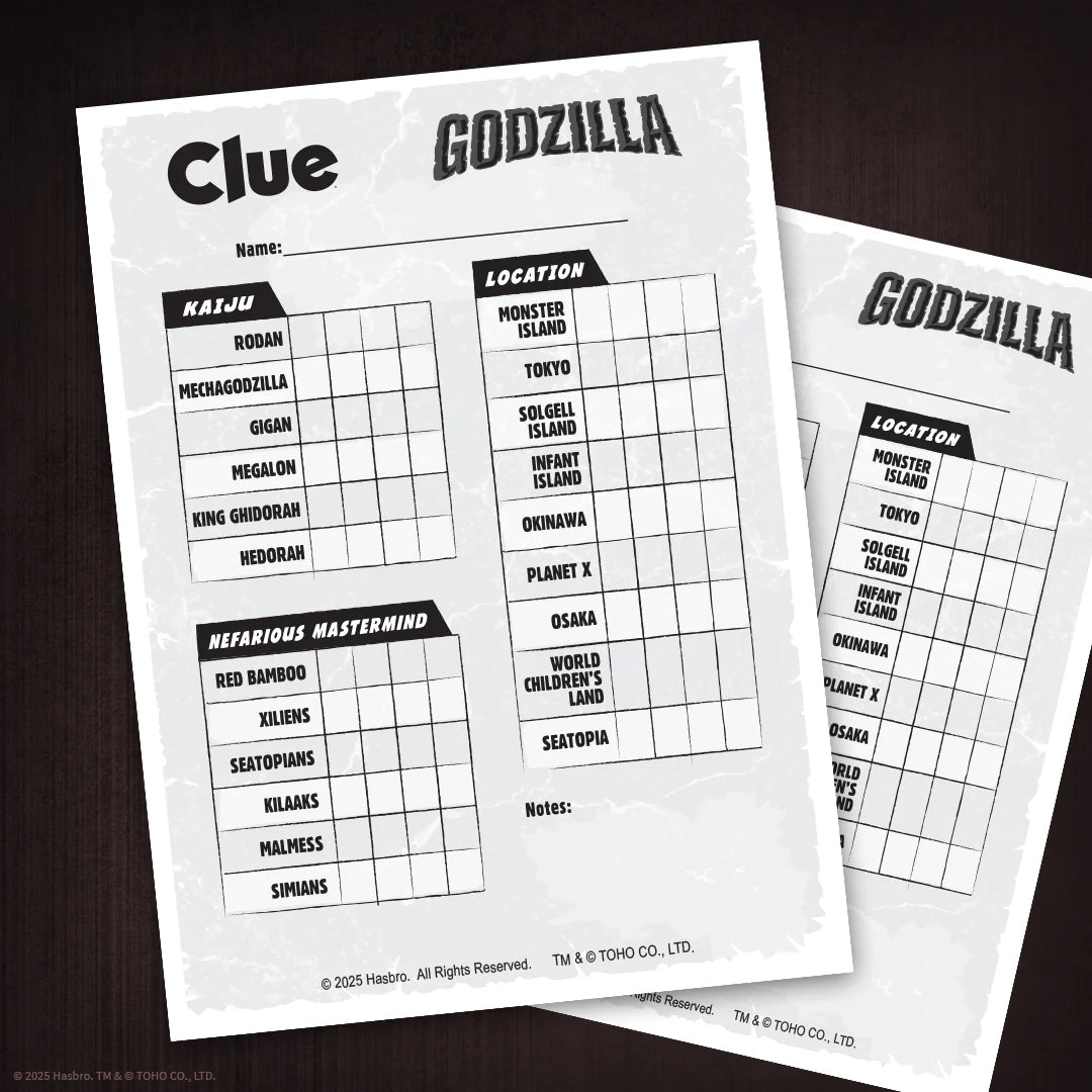 Two printed Clue: Godzilla game sheets laid on a dark wood surface. The front sheet shows clues for Kaiju and Mysterious Mastermind, with a Location grid and the title 'Godzilla' at the top. - Games - Board Games - Clue