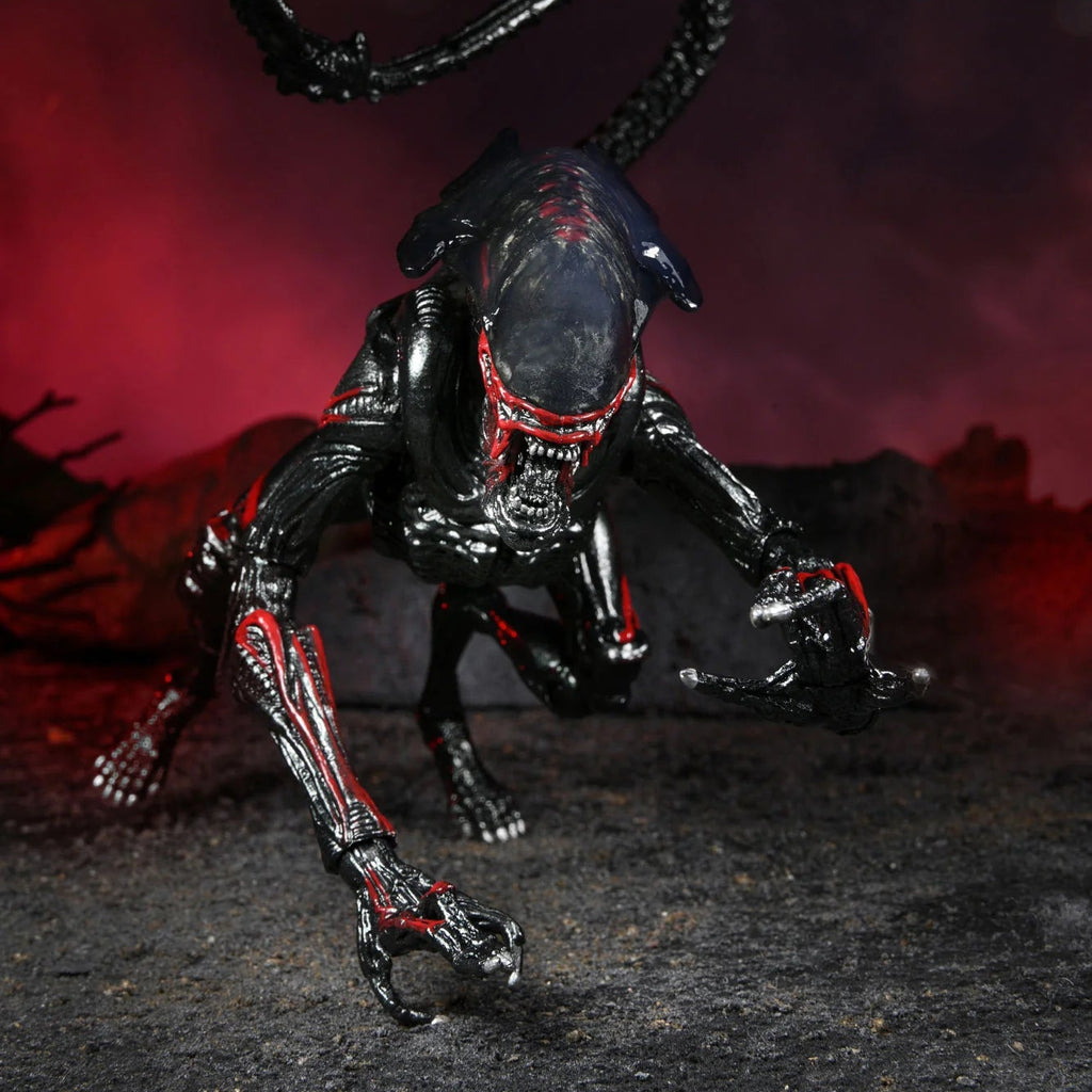 Black and red alien-like creature figure with a dark background