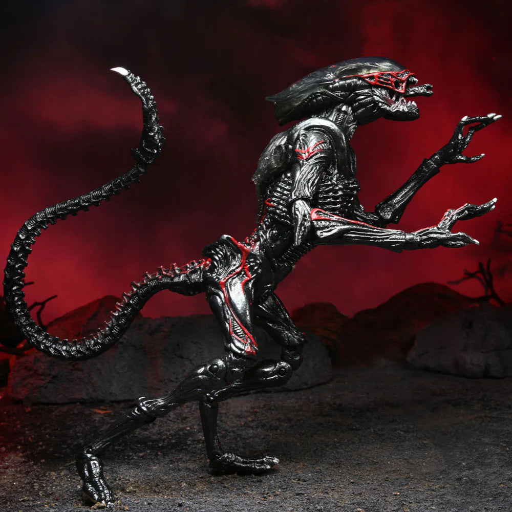 Alien-like creature figurine on a dark background with red lighting
