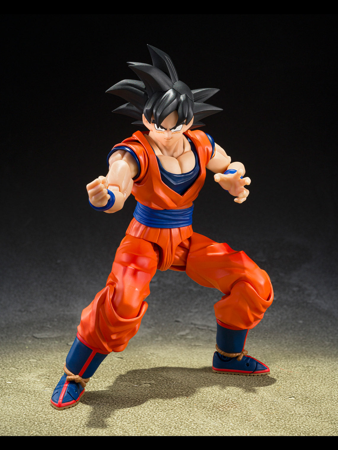 Son Goku action figure posed with shouting expression and wind-swept black hair.