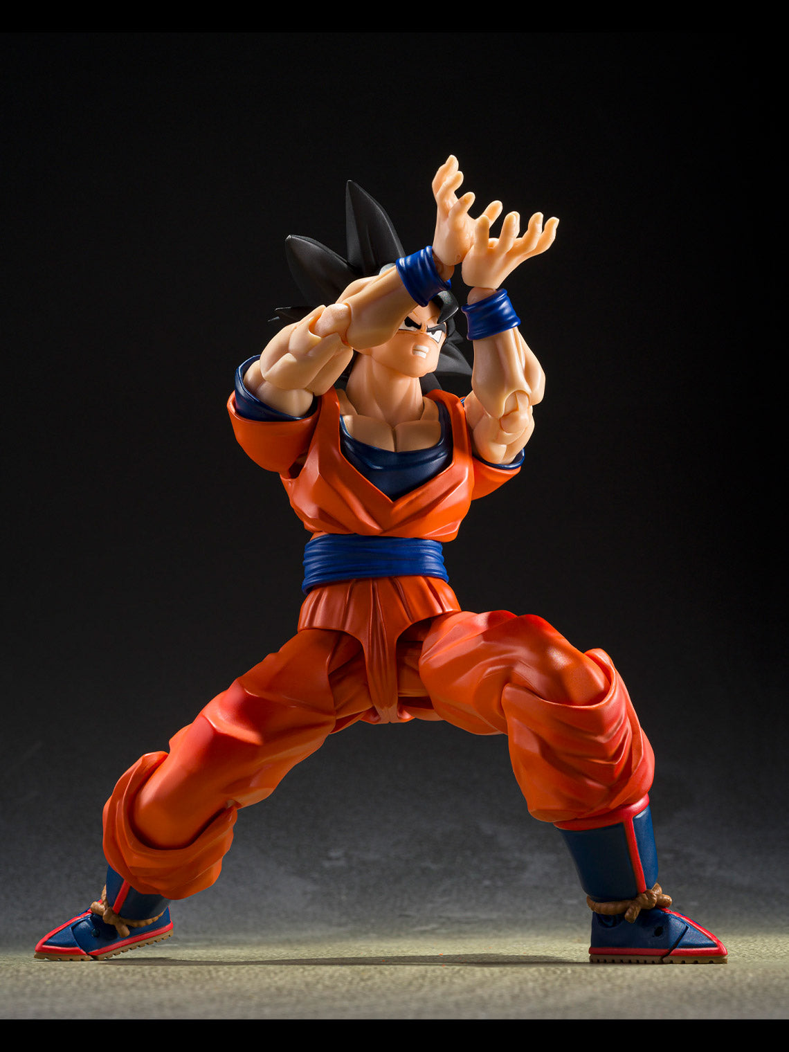 Dragon Ball Z Goku action figure posed with hands together for an energy attack.