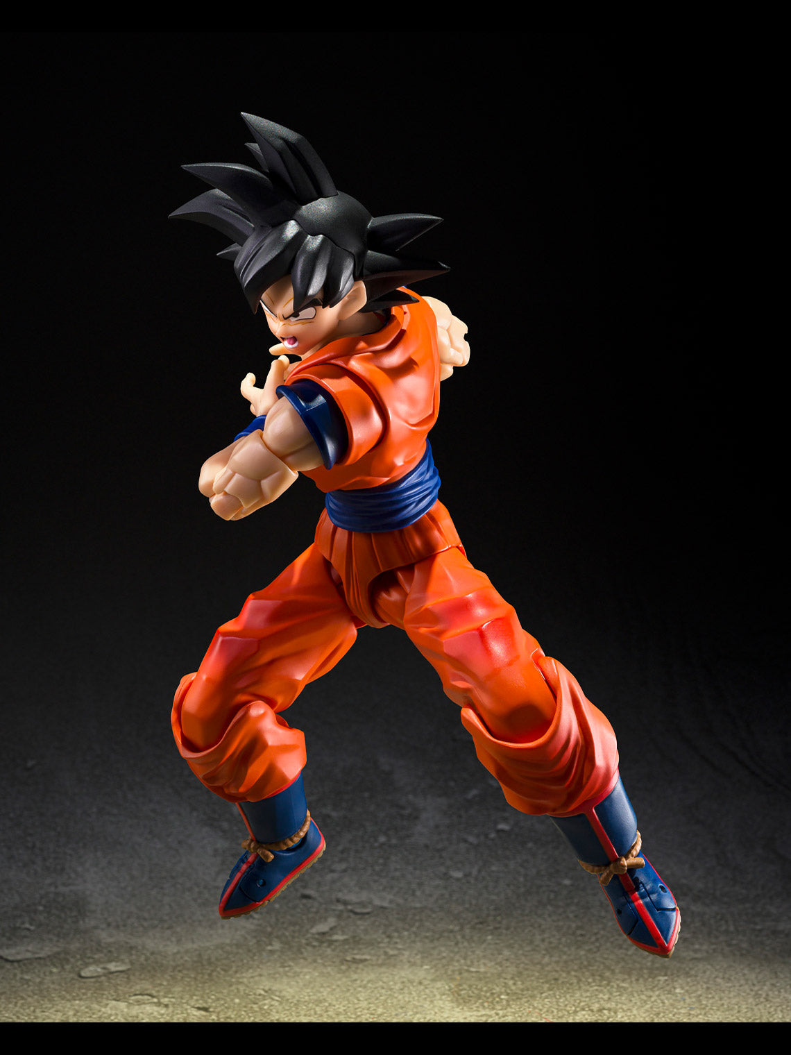 Goku S.H.Figuarts figure posed in an airborne kick wearing his orange-and-blue Cell Saga uniform.