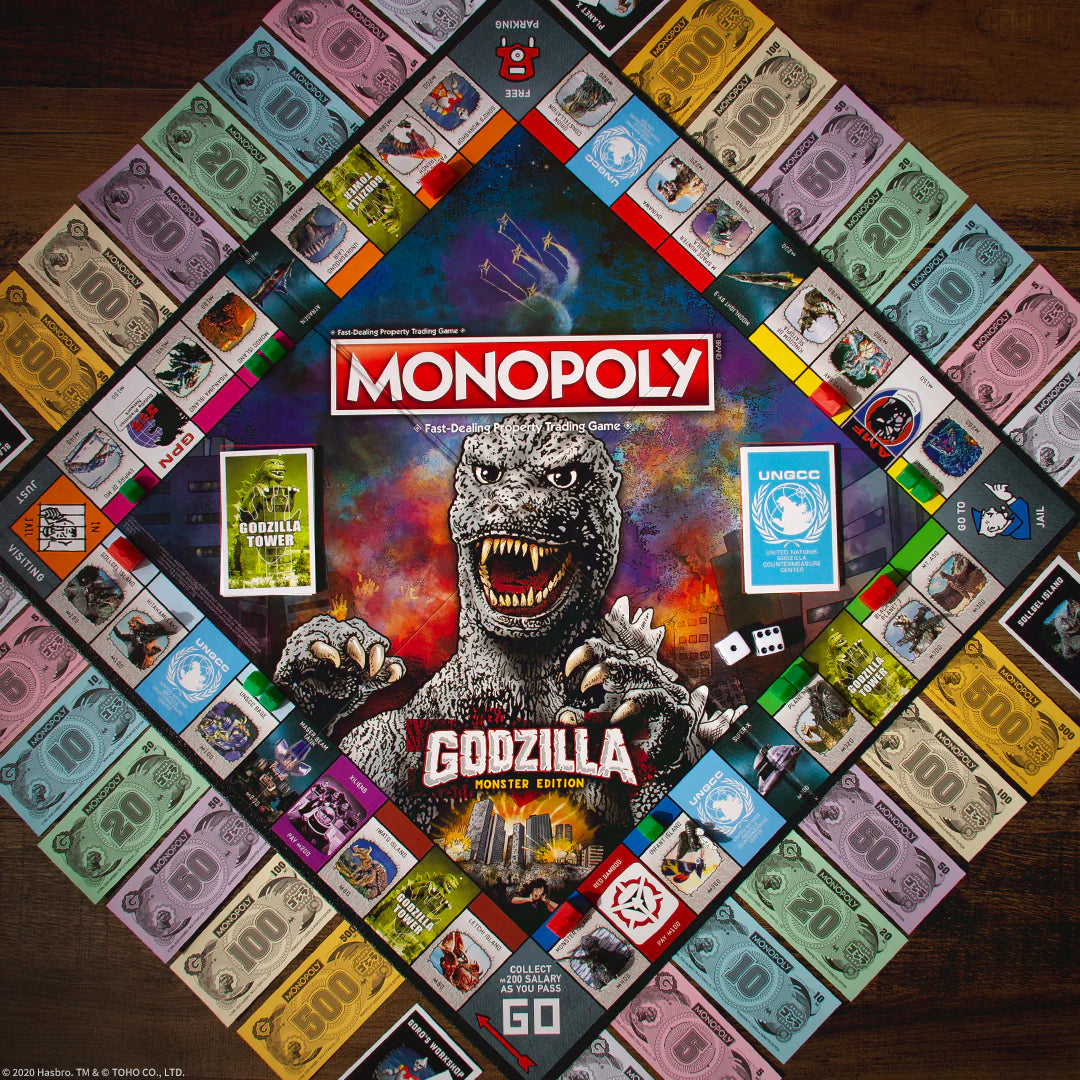 Monopoly board game with Godzilla theme on a wooden surface