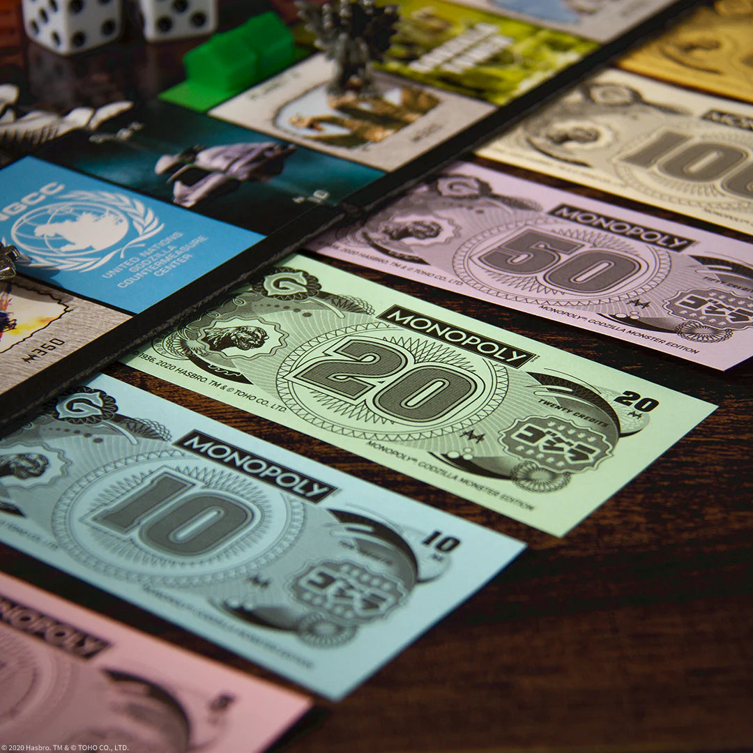 Monopoly game money and cards on a wooden surface