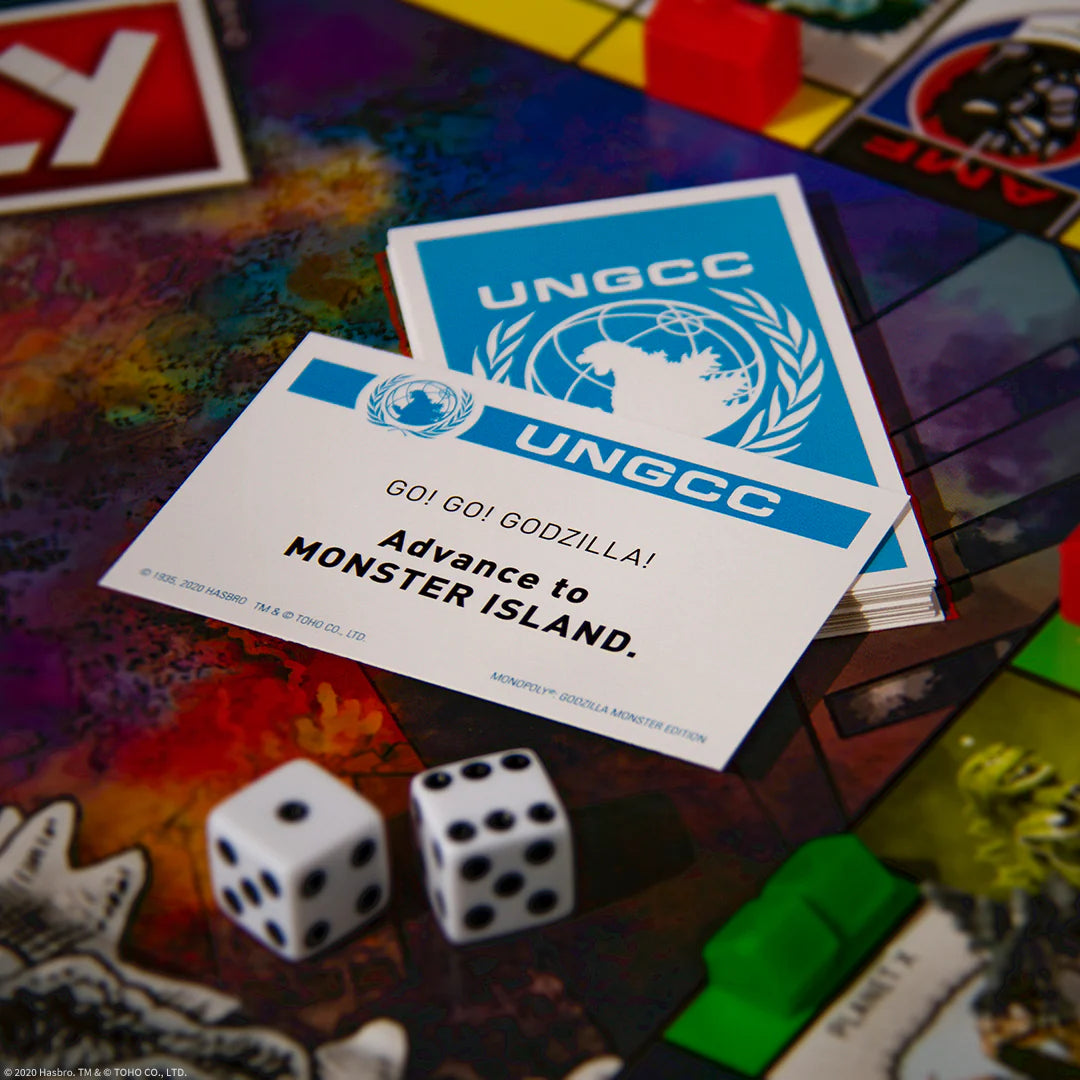 UNGCC cards on a colorful board game with dice