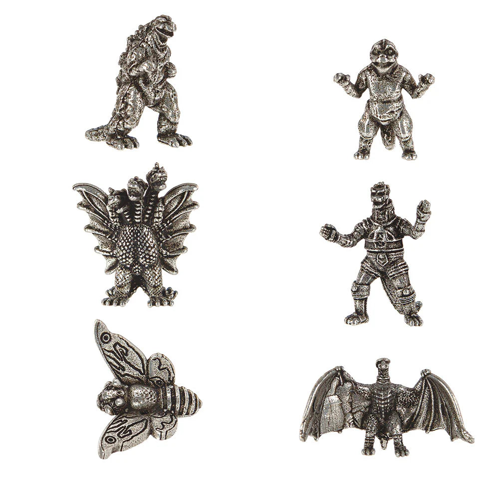 Six silver-toned metal monster and creature charms arranged on a plain white background, including Godzilla, Minilla, King Ghidora, MechaGodzilla, Mothra, and Rodan.