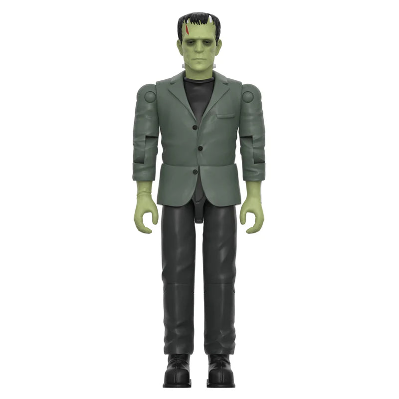 A collectible action figure of Frankenstein's monster wearing a dark gray suit, black shirt, and black pants, standing against a solid white background. - Action Figures - Horror