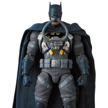 Batman action figure in detailed costume with cape on a white background