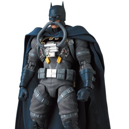 Batman action figure in detailed costume with cape on a white background