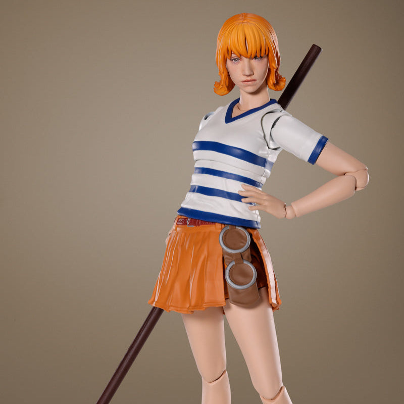 Action figure of a character with orange hair and a staff on a brown background