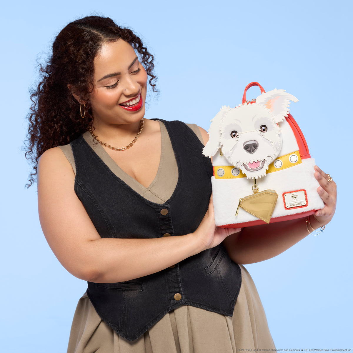 Woman holding a dog-shaped handbag against a blue background - Action Figures - DC Comics