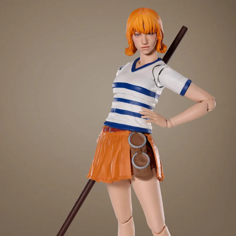 Action figure of a character with orange hair and a staff on a brown background