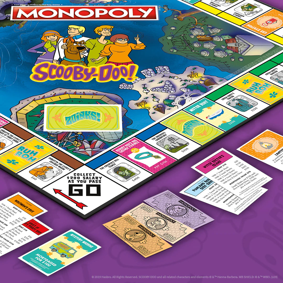 A colorful Monopoly Scooby-Doo! board game set shown at an angle on a purple background, with the game board, play cards, and property tiles visible. - Games - Board Games - Monopoly