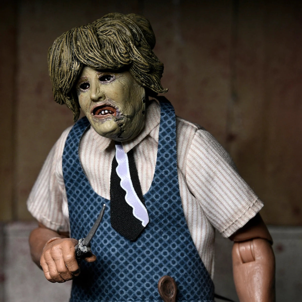 Action figure of a character in a blue apron with a blurred background - Action Figures - Horror