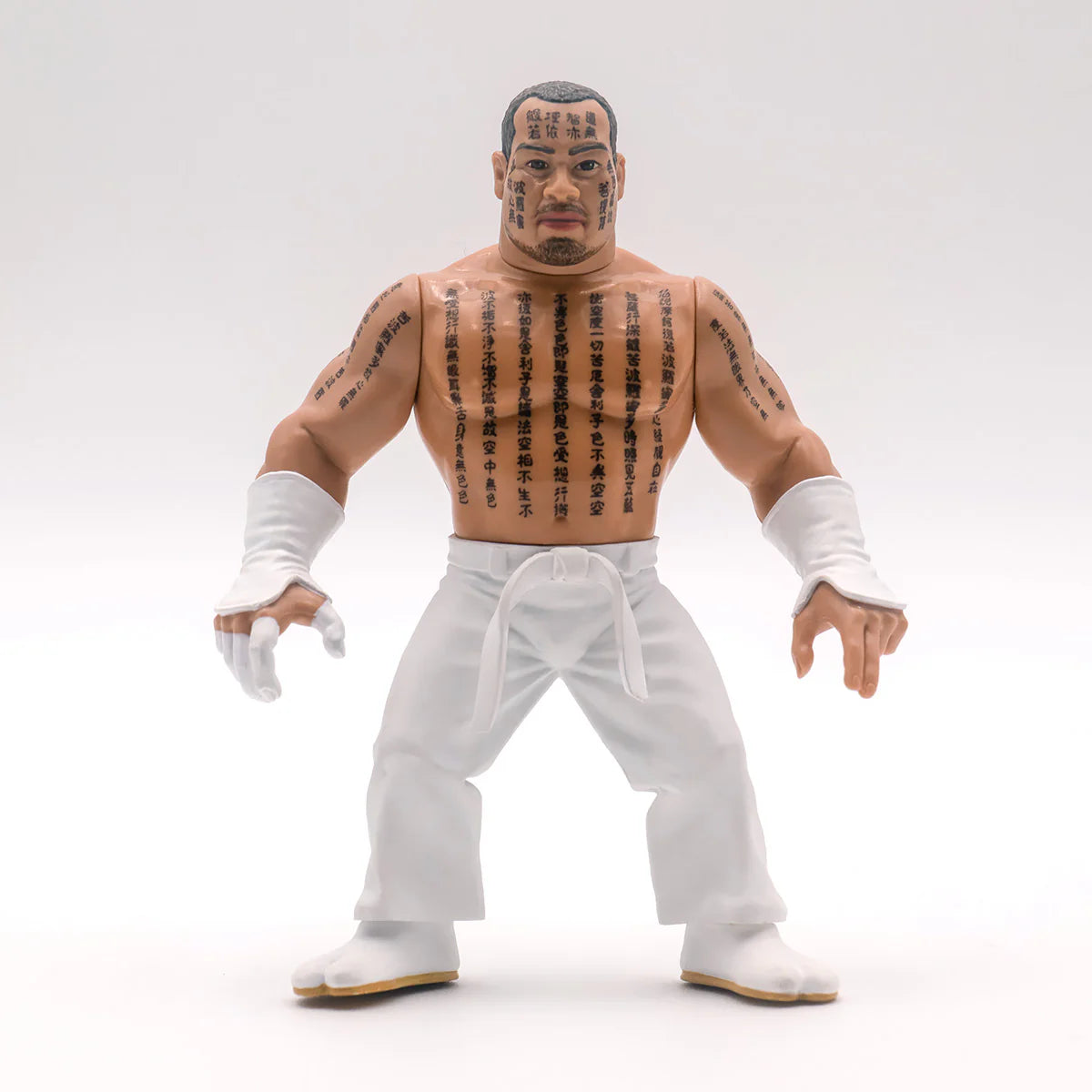 Action figure of Jinsei Shinzaki with tattoos and white pants on a white background - Action Figures - Wrestling