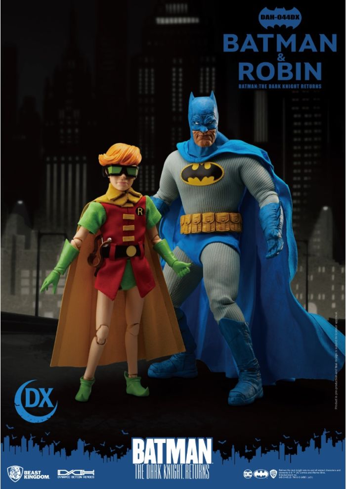 Action figures of Batman and Robin standing together with a cityscape background. - Action Figures - DC Comics